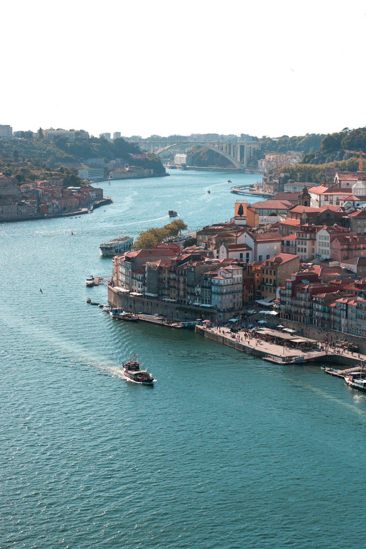 Porto rooftops and the Douro river with a bridge in the distance