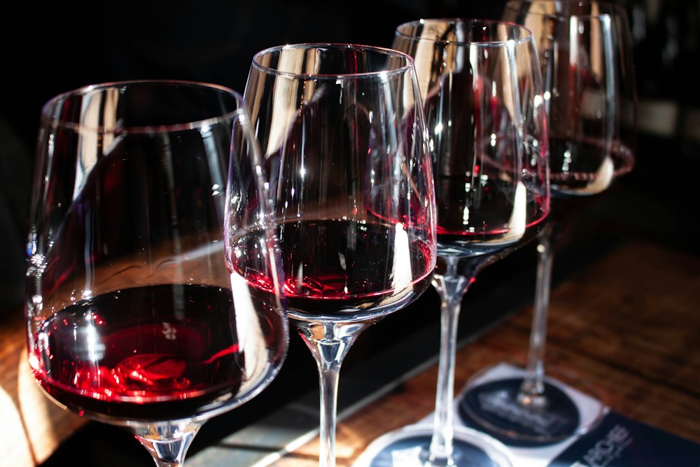 Glasses of red wine catching the light on a tasting table